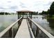 Waterfront view of a covered dock extending into the lake, offering serene and private access to the water at 672 Post Oak Cir # 106, Altamonte Springs, FL 32701