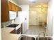 Well-equipped kitchen featuring wood cabinets, tile flooring, and modern appliances at 672 Post Oak Cir # 106, Altamonte Springs, FL 32701