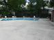 Community pool surrounded by trees and lounge chairs for relaxing enjoyment at 672 Post Oak Cir # 106, Altamonte Springs, FL 32701