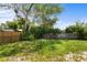 Private backyard featuring mature trees, lush greenery, and partial fencing for added seclusion at 891 N Wayman St, Longwood, FL 32750