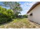 Expansive backyard with lush landscaping and partial home view, perfect for outdoor activities at 891 N Wayman St, Longwood, FL 32750