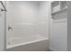 White tile bathtub featuring built-in shelves and silver fixtures at 891 N Wayman St, Longwood, FL 32750