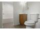 Bathroom featuring a tiled shower and tub combo, wooden vanity, toilet, and mirror at 891 N Wayman St, Longwood, FL 32750