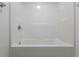 A clean and simple white tiled bathtub with silver fixtures at 891 N Wayman St, Longwood, FL 32750