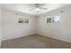 A sunlit carpeted bedroom has two windows at 891 N Wayman St, Longwood, FL 32750