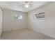 Empty bedroom with carpet floors and two sunny windows at 891 N Wayman St, Longwood, FL 32750