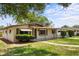 Charming single story home with well-maintained lawn, a walkway, and a covered front porch and carport at 891 N Wayman St, Longwood, FL 32750