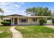 Charming single story home with well-maintained lawn, a walkway, and a covered front porch and carport at 891 N Wayman St, Longwood, FL 32750