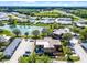 This aerial view shows the community's well-maintained landscaping, lake, and convenient parking near each of the buildings at 917 Royal Oak Blvd, Leesburg, FL 34748