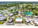 A beautiful aerial view of a planned community with multiple ponds, a community pool, and plenty of lush greenery at 917 Royal Oak Blvd, Leesburg, FL 34748