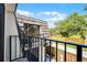 Balcony featuring dark railing and views of mature trees at 917 Royal Oak Blvd, Leesburg, FL 34748