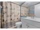 Coastal themed bathroom featuring blue walls, seashell curtain, and white fixtures at 917 Royal Oak Blvd, Leesburg, FL 34748