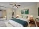 Bright bedroom with ceiling fan and views into the bathroom at 917 Royal Oak Blvd, Leesburg, FL 34748