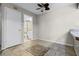 Bedroom showcasing tile flooring, ceiling fan, and ensuite bathroom at 917 Royal Oak Blvd, Leesburg, FL 34748