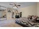 Cozy bedroom featuring a ceiling fan and ensuite bathroom access at 917 Royal Oak Blvd, Leesburg, FL 34748