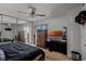 Bedroom features a ceiling fan and large mirrored closet at 917 Royal Oak Blvd, Leesburg, FL 34748