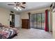 Bedroom with natural light, large windows, and ensuite bathroom at 917 Royal Oak Blvd, Leesburg, FL 34748
