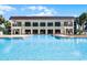 Community pool viewed from poolside building with lounge chairs and covered seating at 917 Royal Oak Blvd, Leesburg, FL 34748