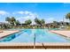Large rectangular community pool with depth markings and nearby lounge chairs at 917 Royal Oak Blvd, Leesburg, FL 34748
