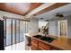 Kitchen features stainless steel appliances and sliding glass doors to the outside at 917 Royal Oak Blvd, Leesburg, FL 34748