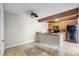 Eat-in kitchen with tile flooring, wood beam, black appliances, and ample counter space at 917 Royal Oak Blvd, Leesburg, FL 34748