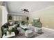 Bright living room with stylish green furniture, modern decor, and ample seating at 917 Royal Oak Blvd, Leesburg, FL 34748