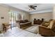 Living room featuring tile floors, a ceiling fan, and sliding glass door at 917 Royal Oak Blvd, Leesburg, FL 34748
