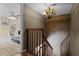 Staircase with adjacent living and bedroom space, featuring modern chandelier at 917 Royal Oak Blvd, Leesburg, FL 34748