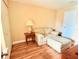 Bedroom features a comfortable armchair with foot rest and laminate floor at 963 Stucki Ter, Winter Garden, FL 34787