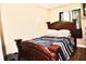 Bedroom features a dark wood bed frame, and a window providing natural light at 963 Stucki Ter, Winter Garden, FL 34787
