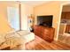 Bedroom featuring a comfortable armchair with dresser and laminate floor at 963 Stucki Ter, Winter Garden, FL 34787