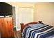 Cozy bedroom with wood-look floors, closet, and wooden dresser at 963 Stucki Ter, Winter Garden, FL 34787