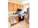 Updated kitchen features stainless steel appliances, granite counters, and stylish wood-look flooring at 963 Stucki Ter, Winter Garden, FL 34787
