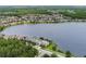 Aerial view of community along lake with mature trees and lush landscape at 10097 Lake District Ln, Orlando, FL 32832