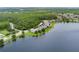 Aerial view of lakeside neighborhood featuring beautiful homes with mature landscaping at 10097 Lake District Ln, Orlando, FL 32832