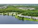Aerial view of lakefront neighborhood with tennis court surrounded by trees at 10097 Lake District Ln, Orlando, FL 32832