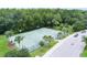 Aerial view of a well-maintained basketball court surrounded by lush greenery and palm trees at 10097 Lake District Ln, Orlando, FL 32832