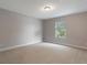 Neutral bedroom with a window and neutral carpet at 10097 Lake District Ln, Orlando, FL 32832