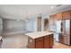 Open floor plan featuring a kitchen island with quartz counters and stainless steel appliances at 10097 Lake District Ln, Orlando, FL 32832