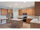 Kitchen area features a stainless steel refrigerator, bar seating and an island at 10097 Lake District Ln, Orlando, FL 32832