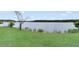 Beautiful lakeside view with a grassy bank; serene waters in the background at 10097 Lake District Ln, Orlando, FL 32832