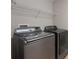 Laundry room includes modern front load Samsung washer and dryer at 10097 Lake District Ln, Orlando, FL 32832