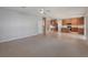 Spacious open-concept living area with tile and carpet, with view of the kitchen and backyard at 10097 Lake District Ln, Orlando, FL 32832