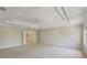 Expansive main bedroom with tray ceiling, fan, and double doors leading to the bathroom at 10097 Lake District Ln, Orlando, FL 32832