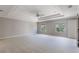 Large main bedroom featuring tray ceiling, windows, and neutral colors at 10097 Lake District Ln, Orlando, FL 32832