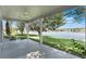 Covered patio with ceiling fan overlooks the lake and lush green backyard at 10097 Lake District Ln, Orlando, FL 32832