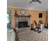 Cozy living room with a brick fireplace and a ceiling fan at 1010 Bolton Rd, New Smyrna Beach, FL 32168