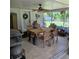 Enclosed back patio with a ceiling fan, dining table, and grill at 1010 Bolton Rd, New Smyrna Beach, FL 32168