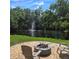 Picturesque pond view with a fountain and fire pit, perfect for relaxation at 1010 Bolton Rd, New Smyrna Beach, FL 32168
