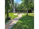 Serene pond with a fountain and a charming seating area, surrounded by lush greenery at 1010 Bolton Rd, New Smyrna Beach, FL 32168